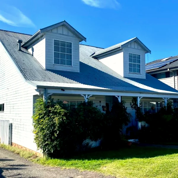 A Sutherland Shire weatherboard home with a newly finished dark metal roof