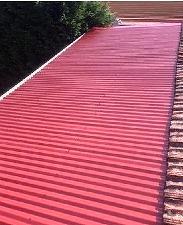 The same roof after restoration, finished in deep red