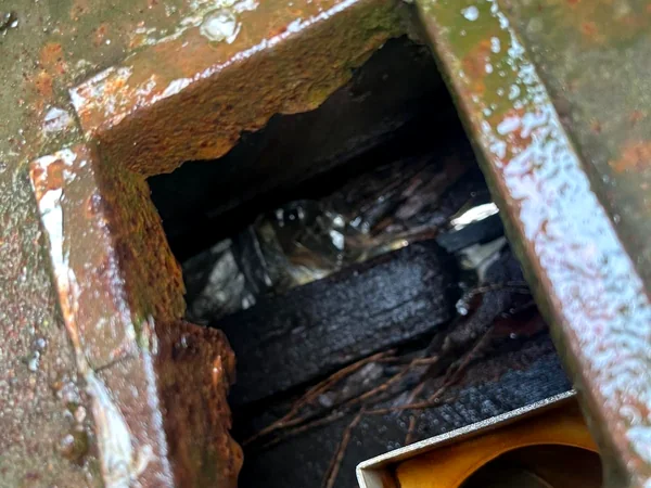 Rusted-through box gutter outlet, a common source of internal water damage