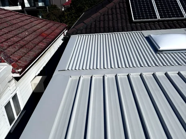 Finished Colorbond roof sitting alongside the original tile