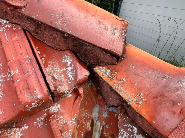 Broken terracotta tiles and perished pointing on an older Shire roof